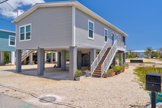 480 E 105th Street Ocean St, Marathon, FL 33050 - view of front of house featuring stairway and a carport
