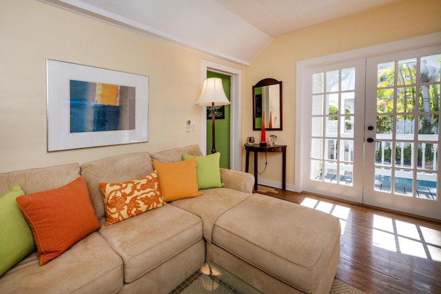 living room featuring lofted ceiling, french doors, baseboards, and wood finished floors