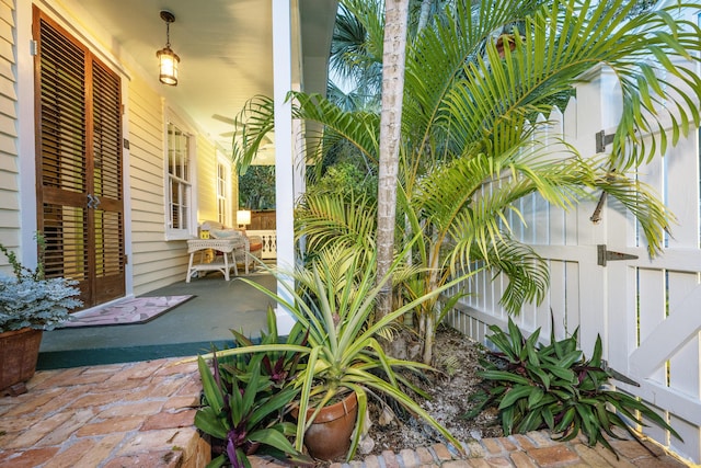 view of patio / terrace with a porch and fence