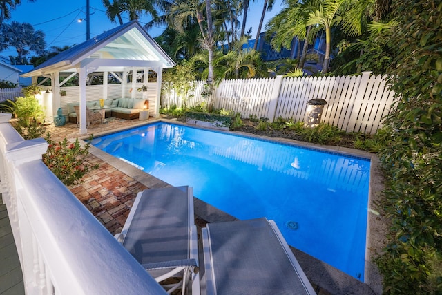 view of pool featuring a fenced in pool, a fenced backyard, a patio, and an outdoor living space