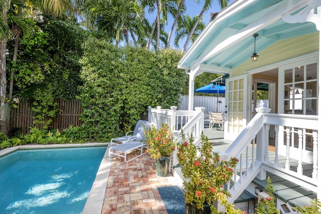 view of pool with a patio area, a fenced backyard, a fenced in pool, and a wooden deck