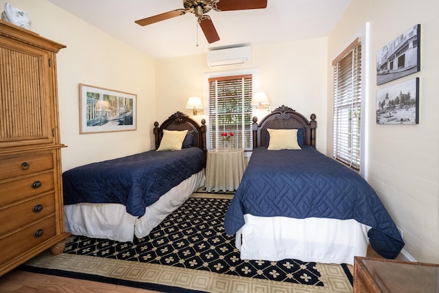 bedroom featuring a wall unit AC and a ceiling fan