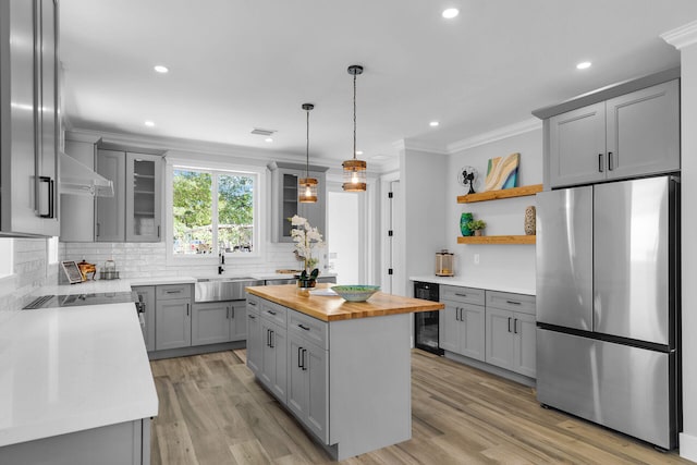 68 Coral Way, Key Largo, FL 33037 - kitchen featuring freestanding refrigerator, wooden counters, gray cabinetry, wine cooler, and ornamental molding