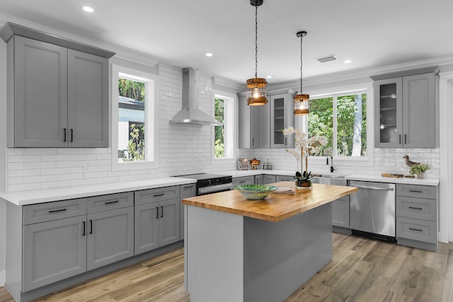 68 Coral Way, Key Largo, FL 33037 - kitchen featuring stainless steel dishwasher, gray cabinets, wall chimney exhaust hood, butcher block countertops, and black range with electric stovetop