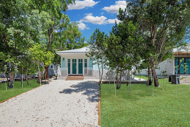 68 Coral Way, Key Largo, FL 33037 - view of front of house with a porch, a front yard, and driveway