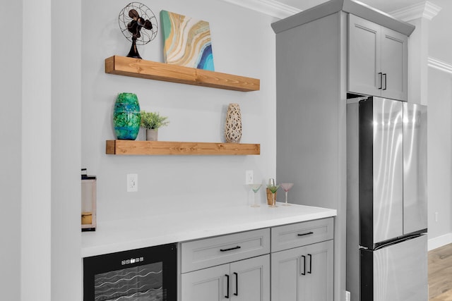 68 Coral Way, Key Largo, FL 33037 - kitchen with open shelves, freestanding refrigerator, beverage cooler, gray cabinetry, and light wood-style flooring