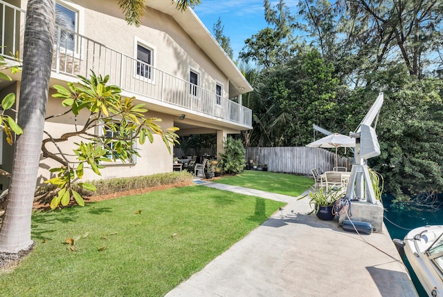 view of yard with a balcony and a patio area