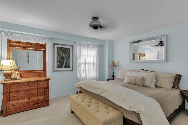 bedroom with light carpet and ceiling fan