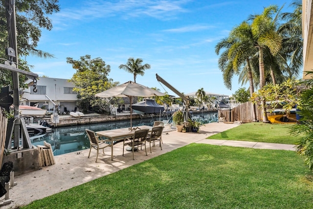 view of yard with a water view and a patio area