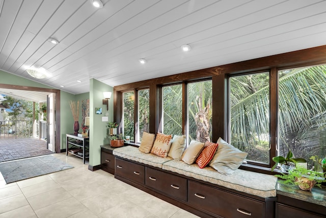 interior space with wooden ceiling, lofted ceiling, and light tile patterned floors