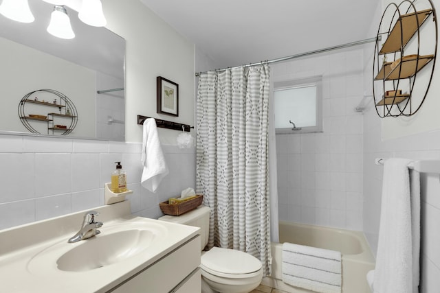 full bathroom with tile walls, shower / tub combo, vanity, and toilet