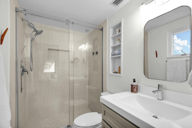 bathroom featuring walk in shower, vanity, and toilet