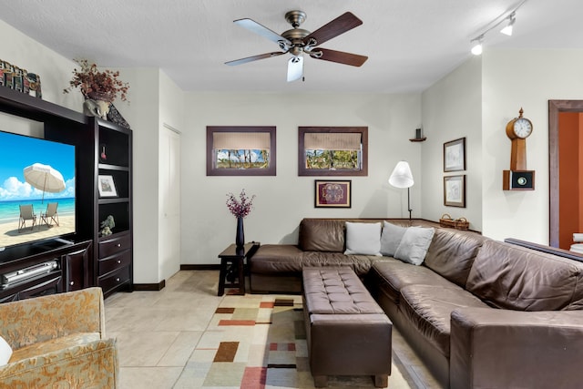 living room featuring ceiling fan, light tile patterned floors, track lighting, and a textured ceiling