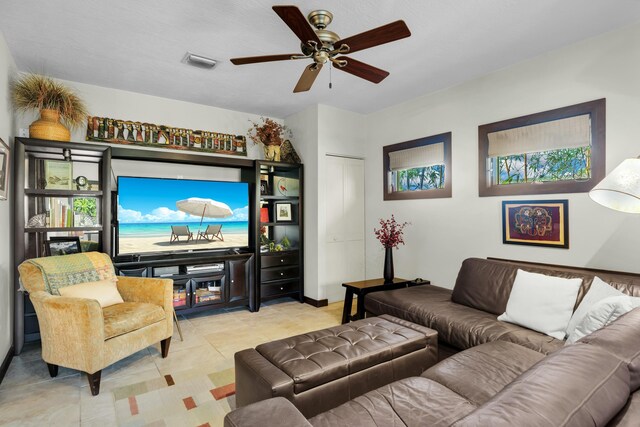 tiled living room with ceiling fan