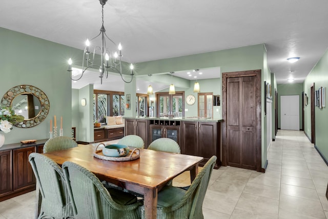 dining area featuring light tile patterned floors and a notable chandelier