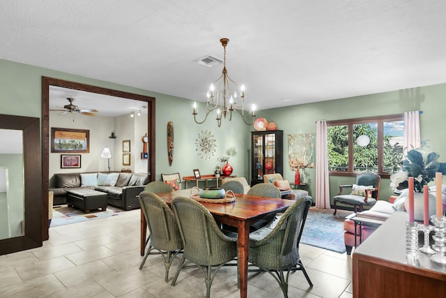 tiled dining space featuring a notable chandelier