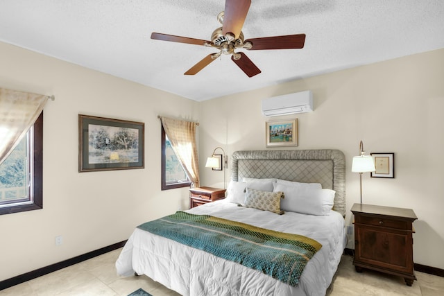 bedroom featuring a wall mounted air conditioner, a textured ceiling, and ceiling fan