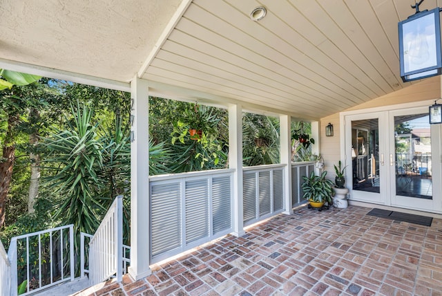 unfurnished sunroom featuring vaulted ceiling and wooden ceiling