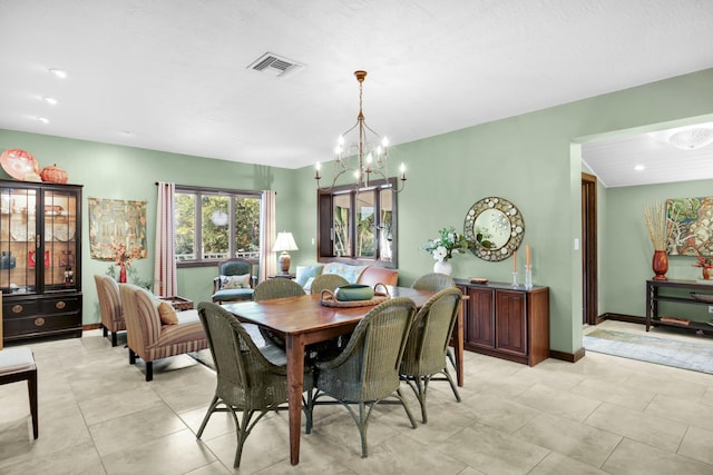 dining space with an inviting chandelier