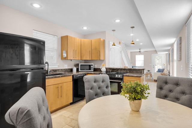 kitchen with black appliances, a sink, a peninsula, light brown cabinets, and recessed lighting
