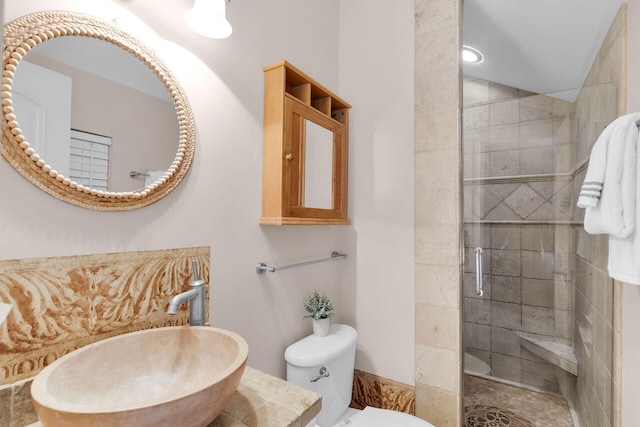 full bathroom with a sink, a shower stall, and toilet