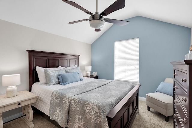 bedroom with light colored carpet, lofted ceiling, baseboards, and a ceiling fan