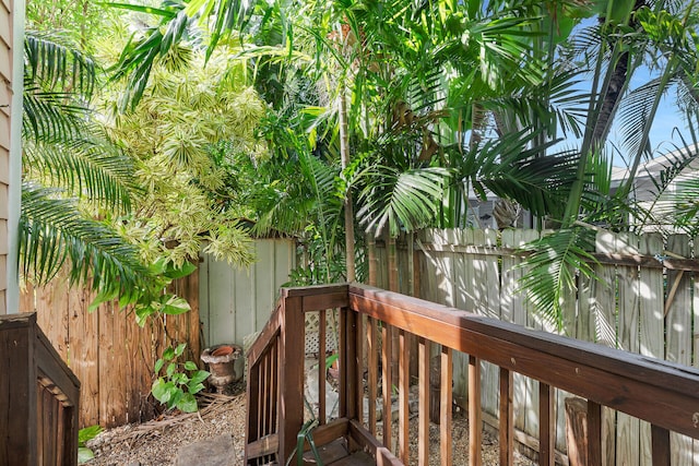 deck featuring a fenced backyard, a storage shed, and an outbuilding
