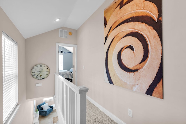 hallway featuring an upstairs landing, carpet, vaulted ceiling, baseboards, and recessed lighting