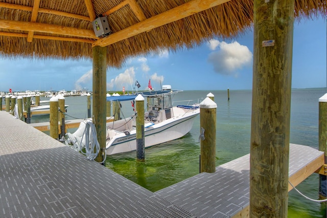 view of dock with a gazebo and a water view