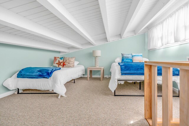 carpeted bedroom featuring beamed ceiling
