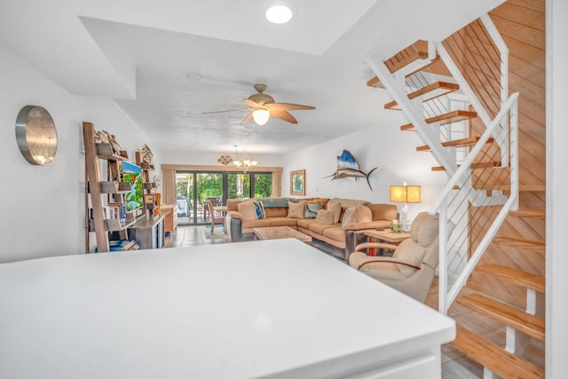 living room with ceiling fan with notable chandelier