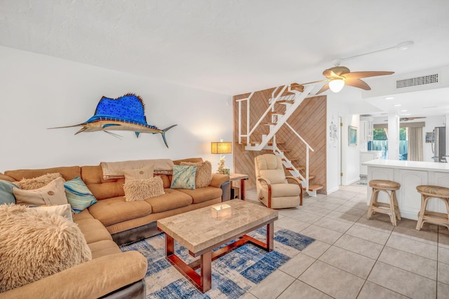 living room with light tile patterned floors and ceiling fan