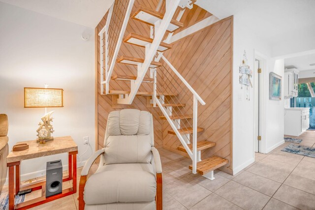 stairway with tile patterned floors