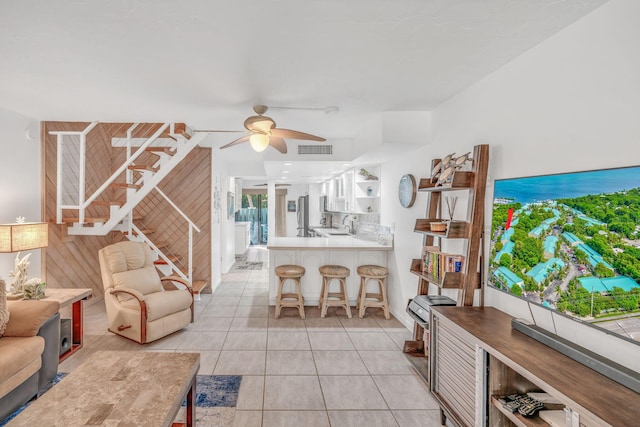 tiled living room featuring ceiling fan