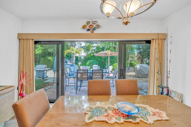 dining space featuring plenty of natural light and a chandelier