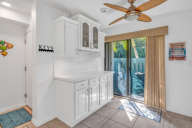 doorway to outside featuring ceiling fan and light tile patterned floors