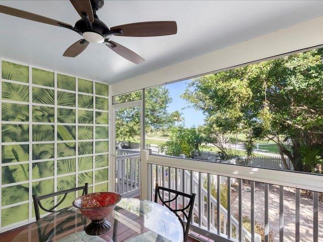 sunroom / solarium featuring ceiling fan