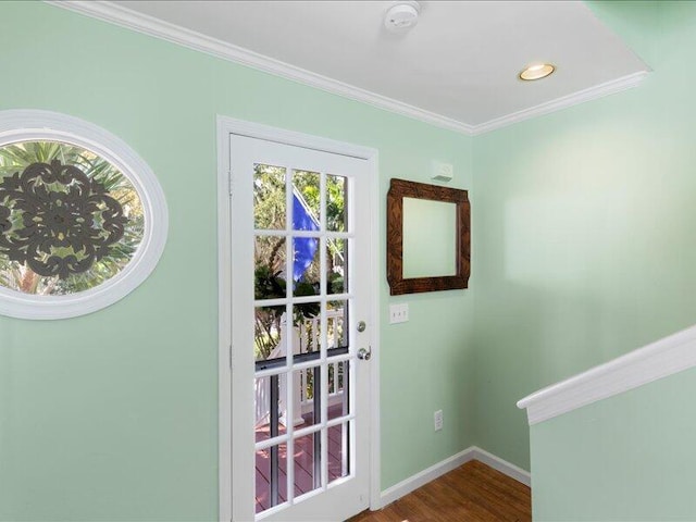 doorway with ornamental molding and wood-type flooring