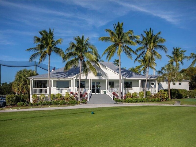 view of front facade featuring covered porch and a front yard