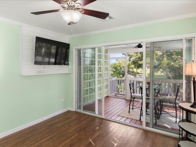 doorway featuring hardwood / wood-style floors, plenty of natural light, and ornamental molding