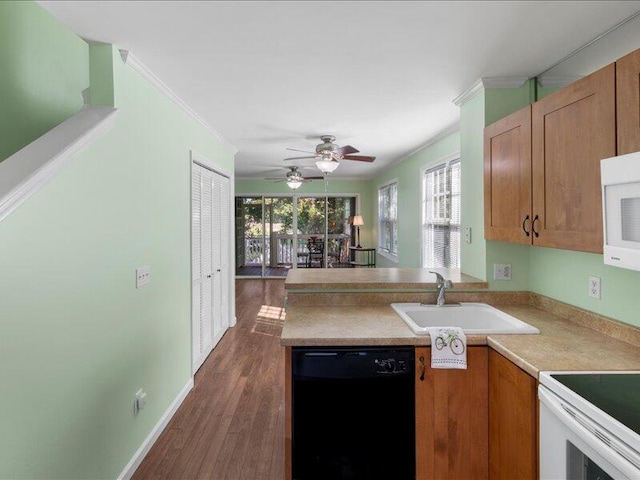 kitchen with crown molding, white appliances, dark hardwood / wood-style floors, and sink