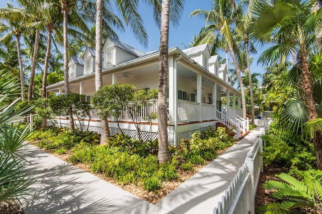 view of property exterior featuring covered porch and ceiling fan