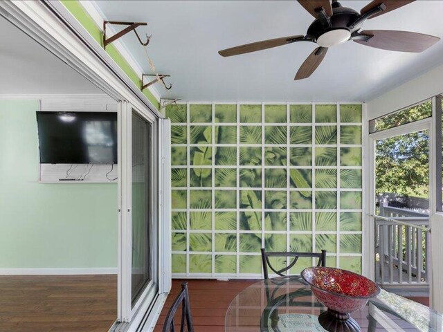 sunroom featuring ceiling fan