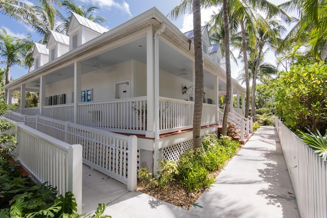 view of side of home with a porch and ceiling fan