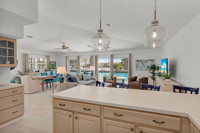 kitchen with open floor plan, visible vents, and light countertops