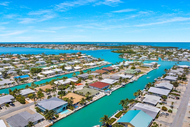 drone / aerial view featuring a water view and a residential view