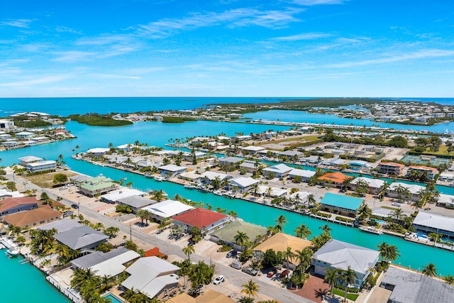 drone / aerial view with a residential view and a water view