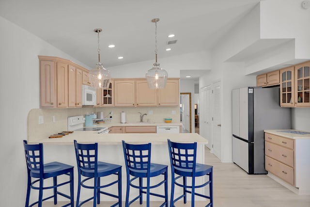 630 10th St, Key Colony, FL 33051 - kitchen featuring white appliances, light brown cabinets, a peninsula, and recessed lighting