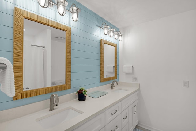 full bath with double vanity and a sink