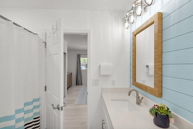 630 10th St, Key Colony, FL 33051 - full bathroom featuring vanity, wood finished floors, and a shower with curtain
